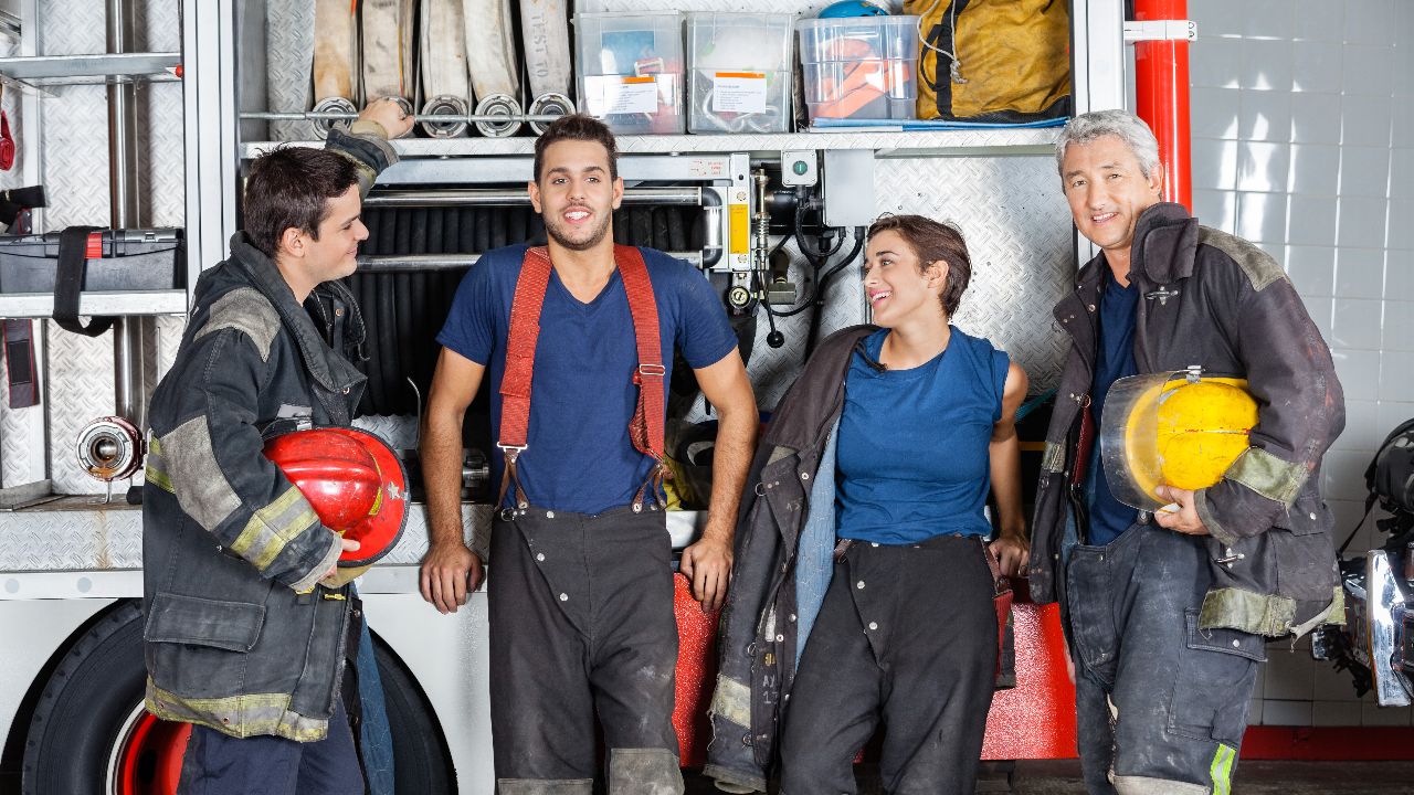 Team Of Confident Firefighters At Fire Station